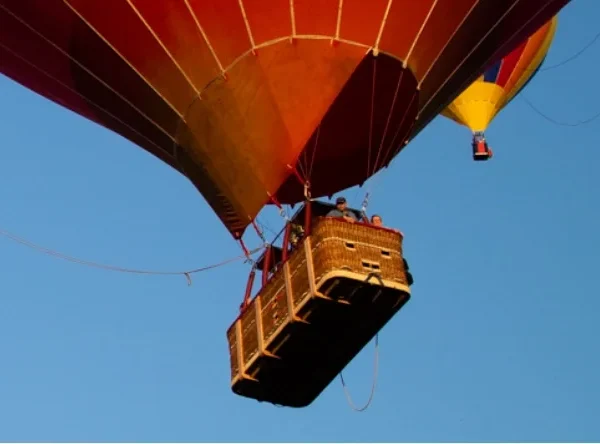 A balloon pilot in a balloon's basket