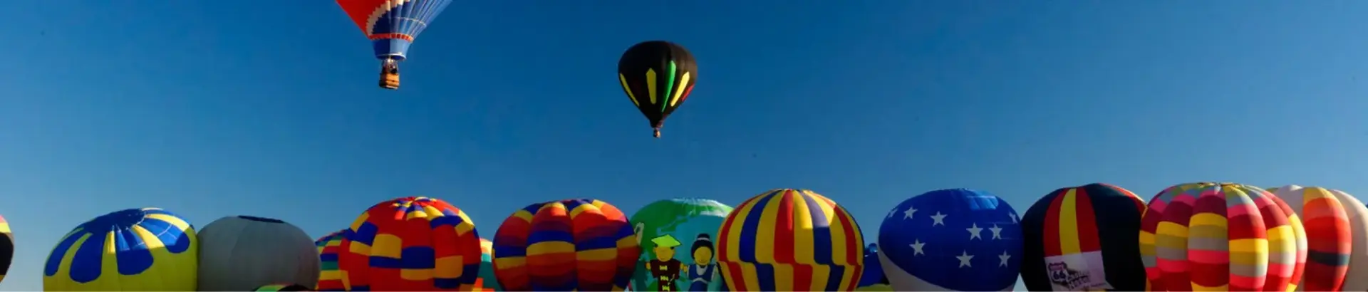 A few hot air balloons in the air and a lot more on the ground in the process of inflating