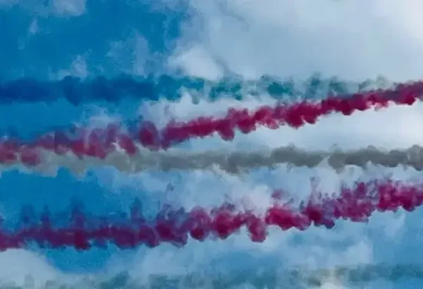 Display jet planes trailing coloured smoke in the sky
